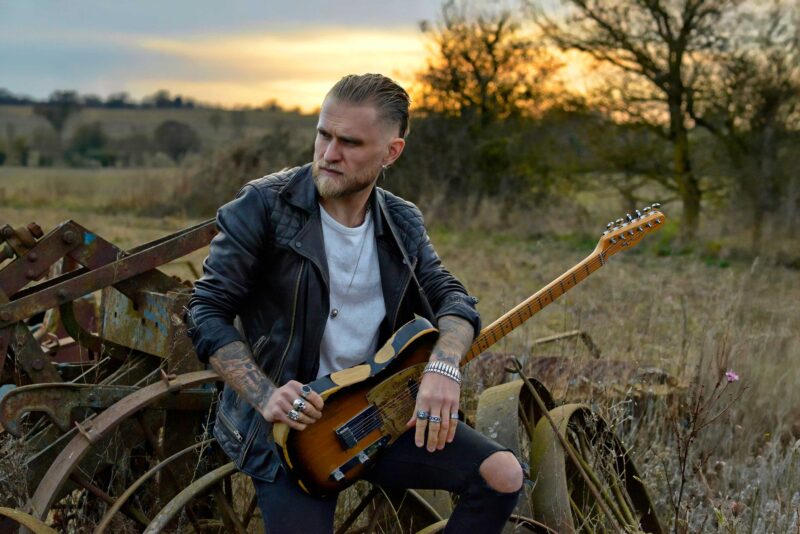 Ben Poole on the bike and guitar