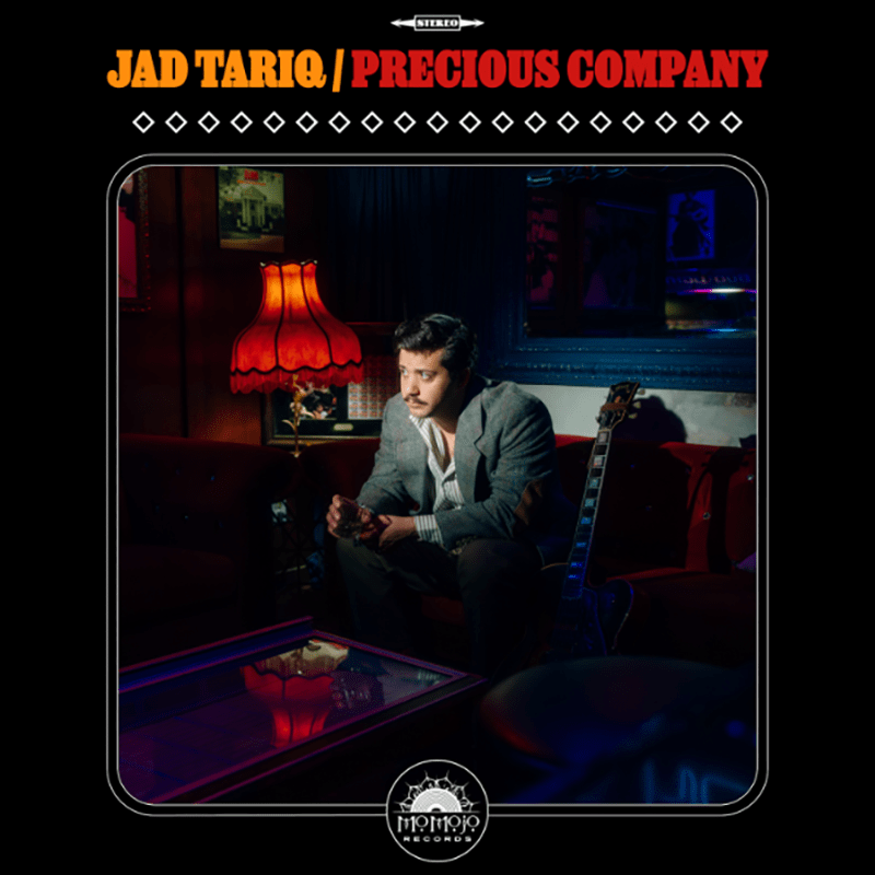 Jad Tariq seated beside a guitar on the cover of Precious Company