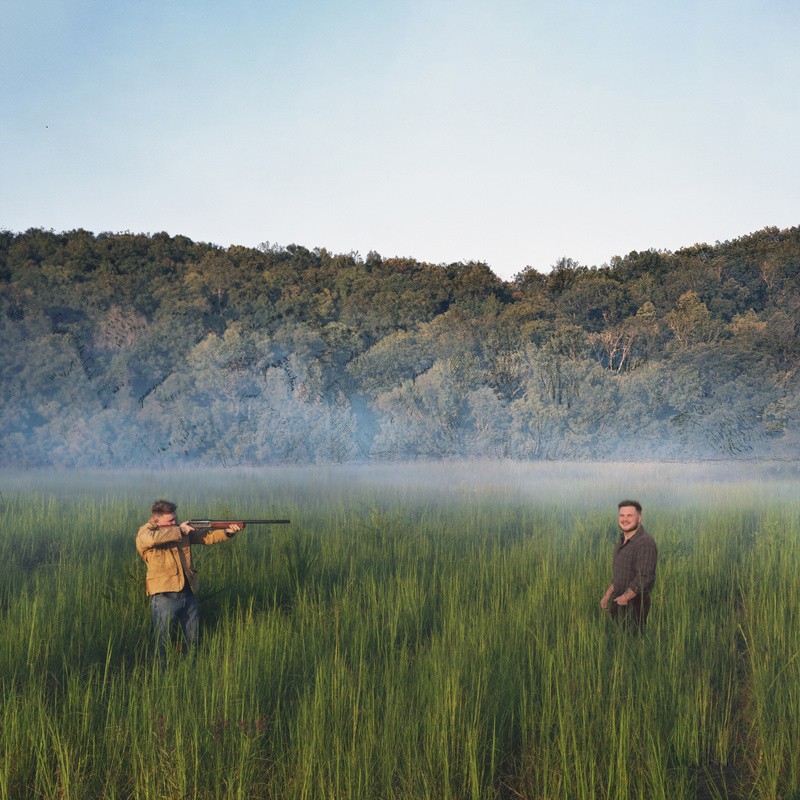 Cover artwork for Zach Bryan's 2026 EP Young Manhood and Other Donatable Organs, showing two men in a grassy landscape.